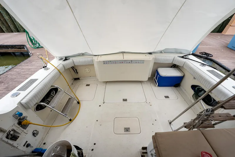 Slide: The Image of 1984 Bertram 33 Sport Fisherman boat deck with seating and storage. - 7