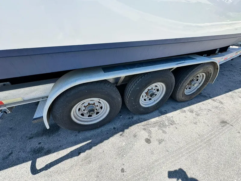 Slide: The Image of Trailer for 2002 Century 3200 Walk-Around boat with triple axle wheels. - 10