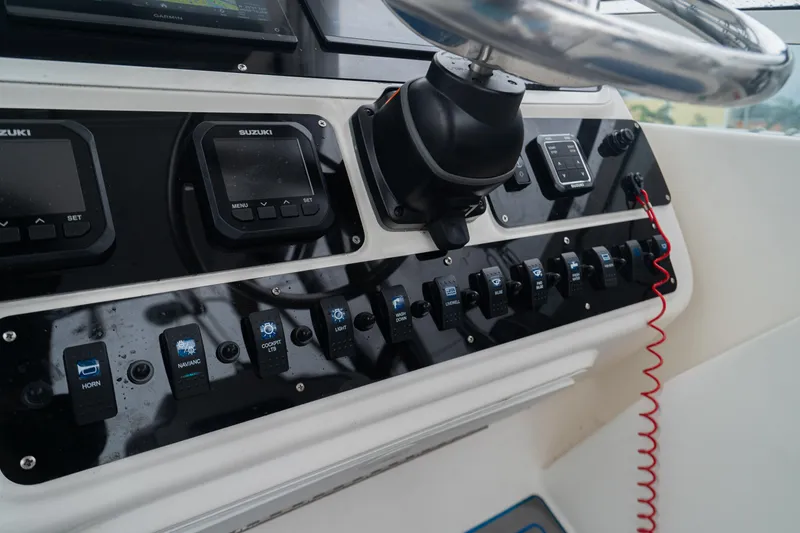 Slide: The Image of Century 3200 Walk-Around 2002 boat dashboard with controls and steering wheel. - 13