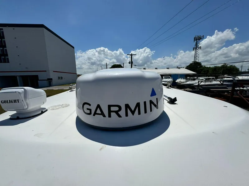 Slide: The Image of Garmin radar on 2002 Century 3200 Walk-Around boat under clear sky. - 16