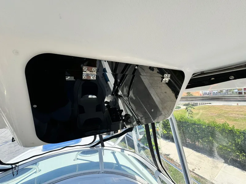 Slide: The Image of 2002 Century 3200 Walk-Around boat interior with black storage compartments. - 17