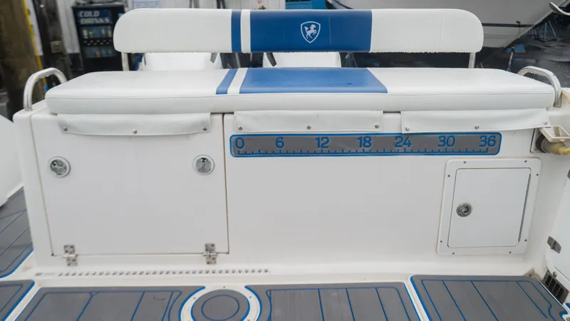 Slide: The Image of Century 3200 Walk-Around 2002 boat seating area with storage and measuring scale. - 18