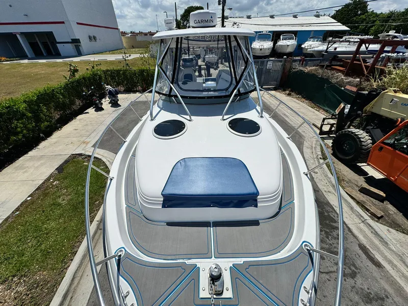 Slide: The Image of 2002 Century 3200 Walk-Around boat docked, featuring Garmin electronics and spacious deck. - 2