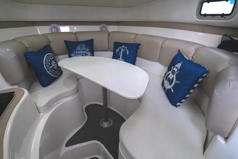 Slide: The Image of Cozy interior of 2002 Century 3200 Walk-Around boat with nautical-themed cushions. - 22