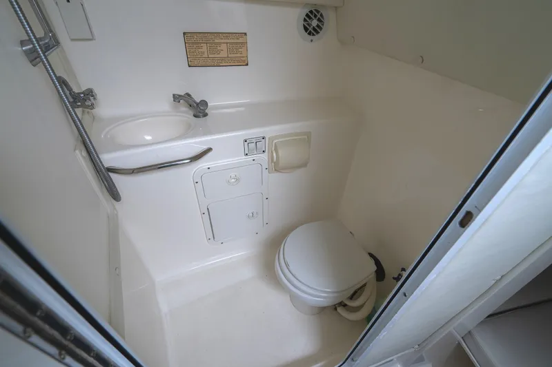 Slide: The Image of 2002 Century 3200 Walk-Around boat bathroom with sink and toilet. - 26