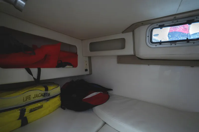 Slide: The Image of Interior cabin of 2002 Century 3200 Walk-Around with life jackets and window. - 27