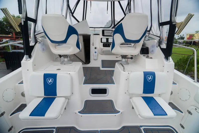 Slide: The Image of 2002 Century 3200 Walk-Around boat interior with blue and white seating. - 28