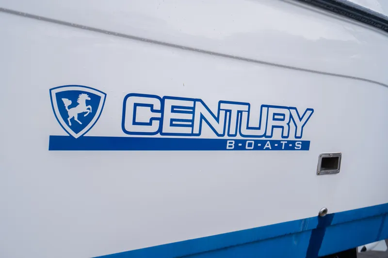 Slide: The Image of Century 3200 Walk-Around 2002 boat logo on white and blue hull. - 4