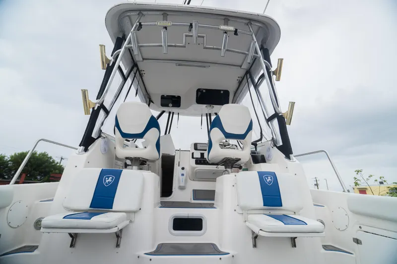 Slide: The Image of 2002 Century 3200 Walk-Around boat with dual seating and fishing rod holders. - 6