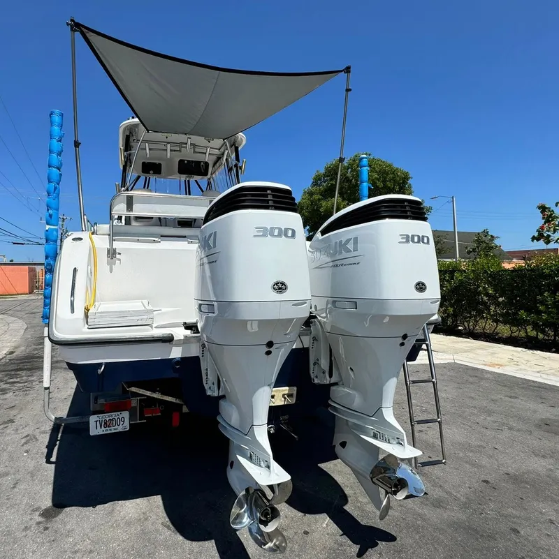 Slide: The Image of 2002 Century 3200 Walk-Around boat with twin Suzuki 300 outboard engines. - 7