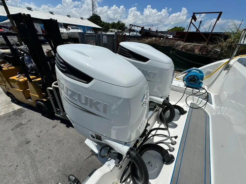 Slide: The Image of 2002 Century 3200 Walk-Around boat with twin Suzuki outboard engines. - 8