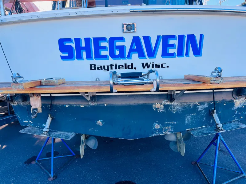Slide: The Image of 1976 Trojan F 32 boat named "SHEGAVEIN" in Bayfield, Wisconsin, on stands. - 6