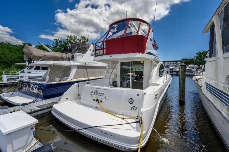 Slide: The Image of 2005 Sea Ray 420 Sedan Bridge docked at a marina on a sunny day. - 11