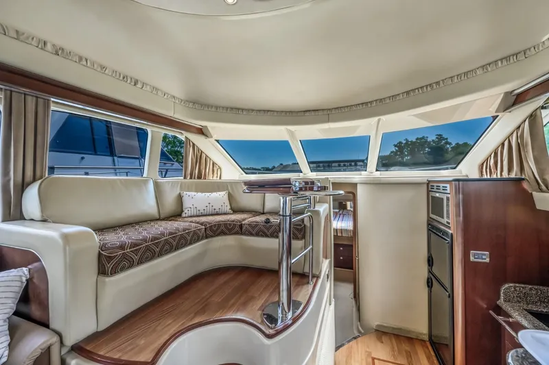 Slide: The Image of Interior of a 2005 Sea Ray 420 Sedan Bridge yacht with panoramic windows. - 16