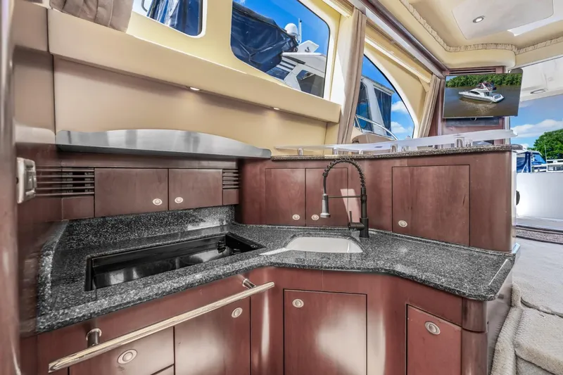 Slide: The Image of Luxurious kitchen area in 2005 Sea Ray 420 Sedan Bridge yacht with granite countertops. - 19