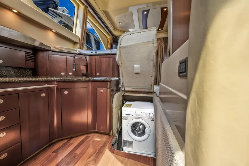 Slide: The Image of 2005 Sea Ray 420 Sedan Bridge kitchen with built-in washer and dryer. - 20