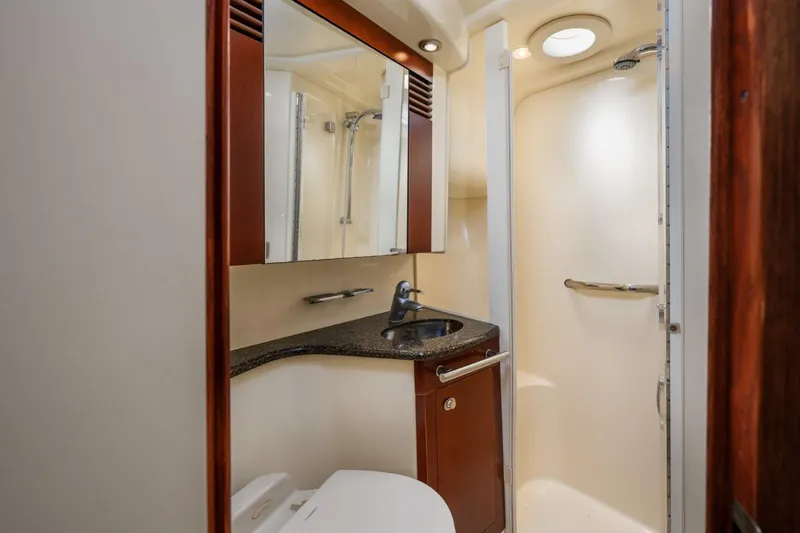 Slide: The Image of 2005 Sea Ray 420 Sedan Bridge bathroom with sink, mirror, and shower. - 23