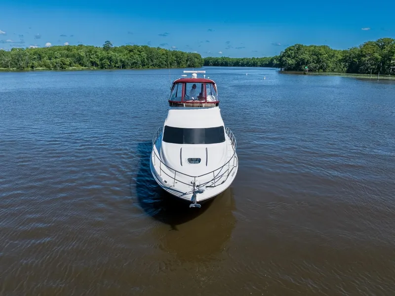 Slide: The Image of 2005 Sea Ray 420 Sedan Bridge on a calm river. - 4