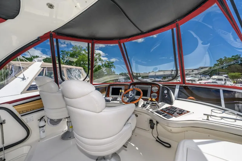 Slide: The Image of 2005 Sea Ray 420 Sedan Bridge helm with dual captain chairs and panoramic view. - 8