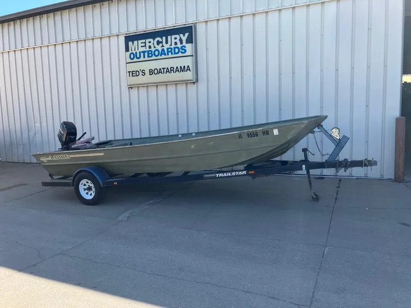 The Image of 1994 Lowe 1960 HUSKY boat on a trailer outside Ted's Boatarama. - 1