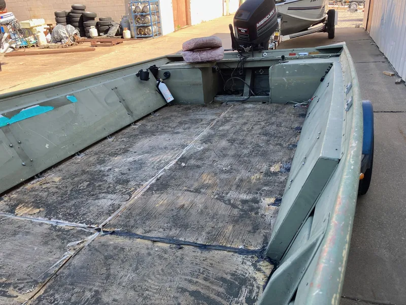 Slide: The Image of 1994 Lowe 1960 HUSKY boat with outboard motor and worn interior. - 4