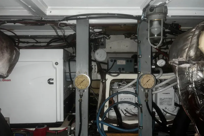 Slide: The Image of Engine room of a 1981 Hatteras 48 Motor Yacht with gauges and equipment. - 19