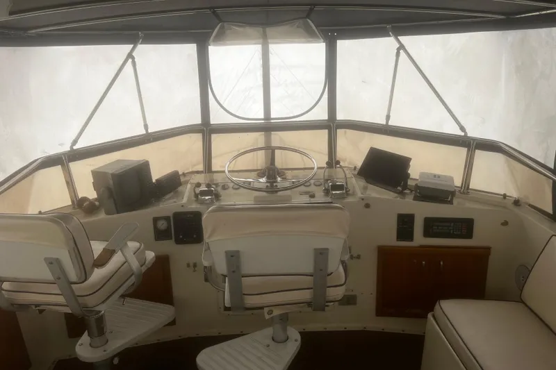 Slide: The Image of 1981 Hatteras 48 Motor Yacht helm with steering wheel and navigation equipment. - 20