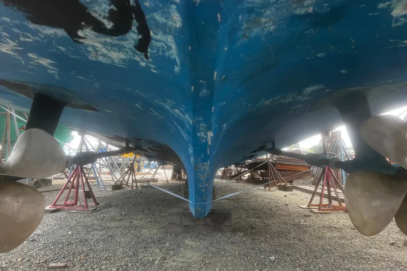 Slide: The Image of Underside view of 1981 Hatteras 48 Motor Yacht with visible propellers and supports. - 24