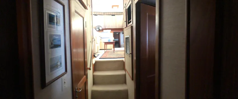 Slide: The Image of Interior hallway of 1981 Hatteras 48 Motor Yacht with carpeted steps and wooden paneling. - 7