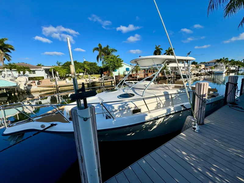Slide: The Image of 2006 Century 3200 Walk-Around boat docked at a marina on a sunny day. - 0