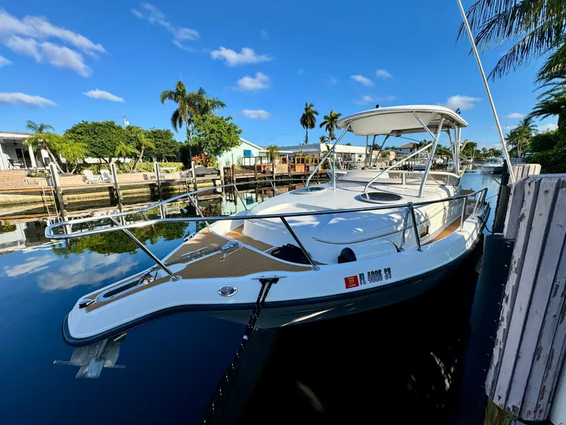 Slide: The Image of 2006 Century 3200 Walk-Around boat docked in a sunny marina. - 1