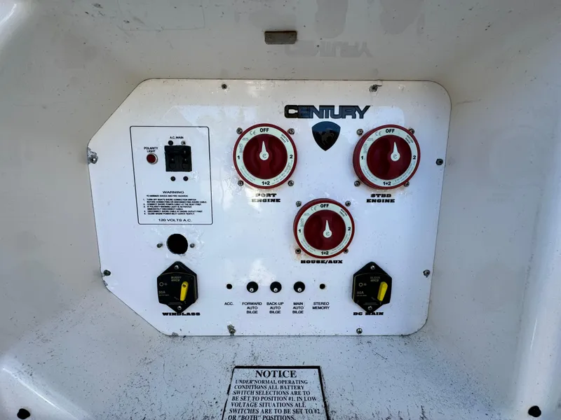 Slide: The Image of Control panel of a 2006 Century 3200 Walk-Around boat with various switches and dials. - 12