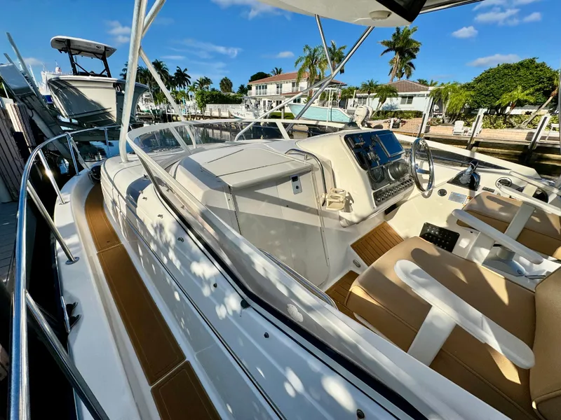 Slide: The Image of 2006 Century 3200 Walk-Around boat docked at a marina with palm trees. - 13
