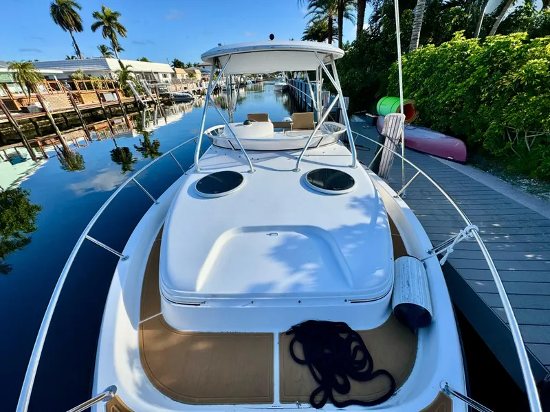 Slide: The Image of 2006 Century 3200 Walk-Around boat docked by a scenic canal. - 14