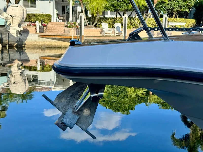 Slide: The Image of 2006 Century 3200 Walk-Around boat with anchor, docked in a serene waterfront setting. - 16