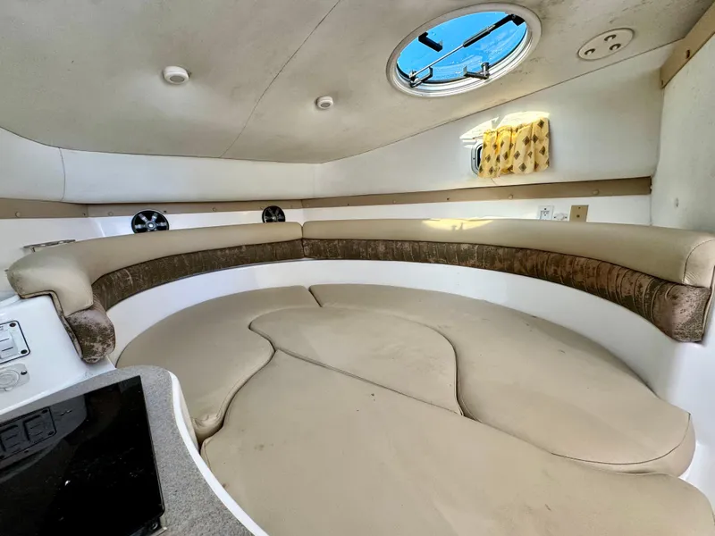 Slide: The Image of 2006 Century 3200 Walk-Around cabin interior with circular seating and porthole. - 19