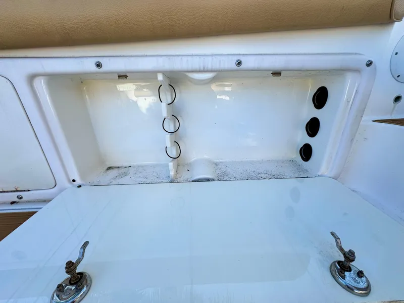 Slide: The Image of Open storage compartment on a 2006 Century 3200 Walk-Around boat. - 24