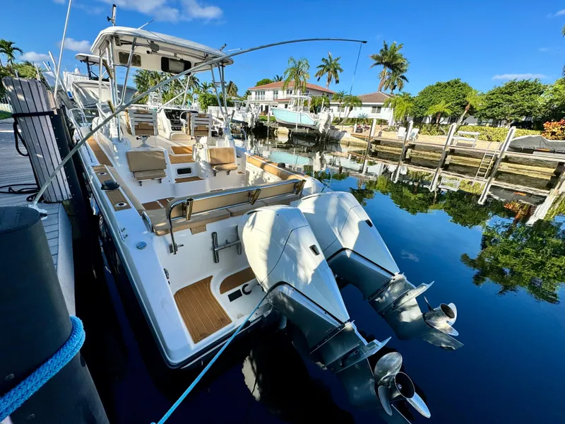 Slide: The Image of 2006 Century 3200 Walk-Around boat docked in a sunny marina. - 3