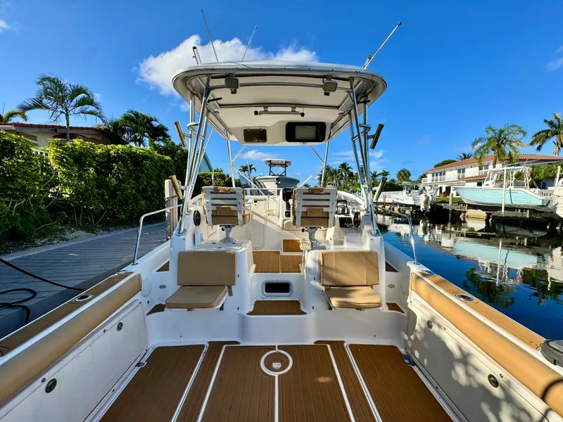 Slide: The Image of 2006 Century 3200 Walk-Around boat docked, featuring spacious seating and modern amenities. - 6