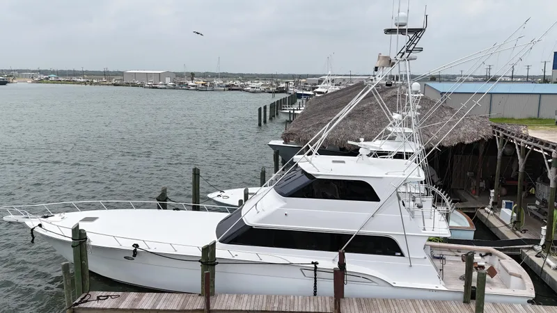 Slide: The Image of 1996 Donzi Custom Enclosed Flybridge yacht docked at a marina. - 0