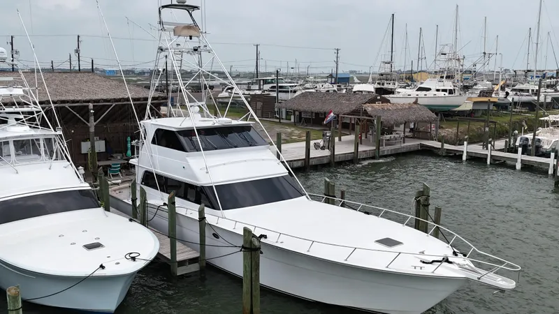 Slide: The Image of 1996 Donzi Custom Enclosed Flybridge yacht docked at a marina. - 15