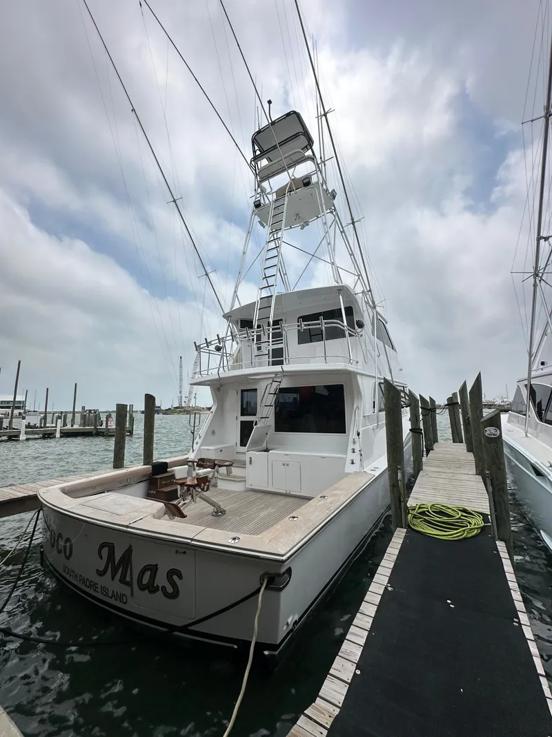 Slide: The Image of 1996 Donzi Custom Enclosed Flybridge yacht docked at marina under cloudy sky. - 17