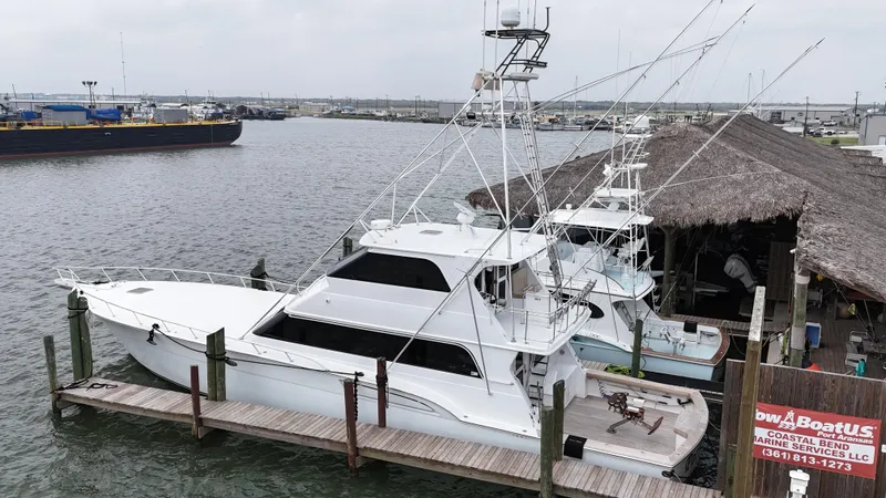 Slide: The Image of 1996 Donzi Custom Enclosed Flybridge yacht docked at marina. - 2