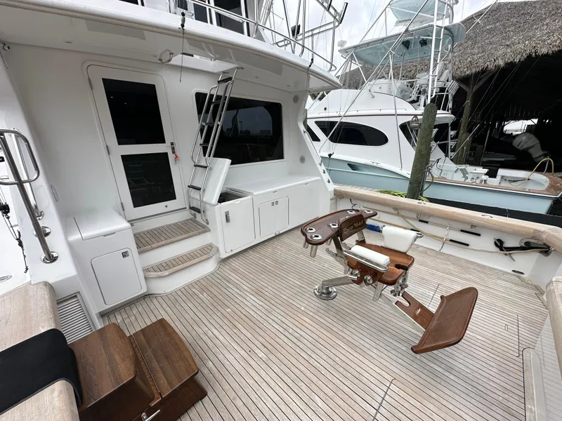 Slide: The Image of 1996 Donzi Custom Enclosed Flybridge yacht deck with fishing chair and teak flooring. - 22