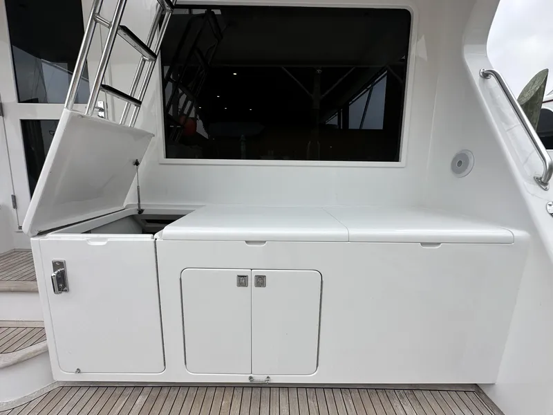 Slide: The Image of 1996 Donzi Custom Enclosed Flybridge with storage compartments and ladder. - 23