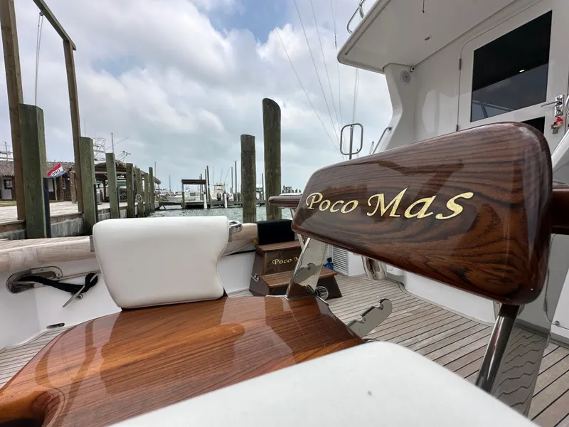 Slide: The Image of 1996 Donzi Custom Enclosed Flybridge boat with Poco MaS nameplate at a marina. - 27