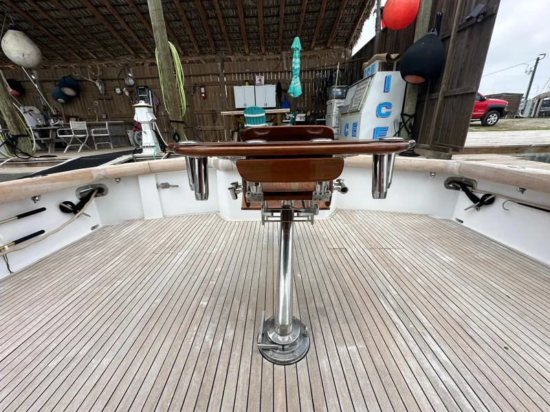 Slide: The Image of 1996 Donzi Custom Enclosed Flybridge deck with fishing chair and rod holders. - 28