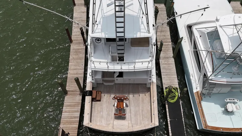 Slide: The Image of 1996 Donzi Custom Enclosed Flybridge yacht docked at marina, aerial view. - 3