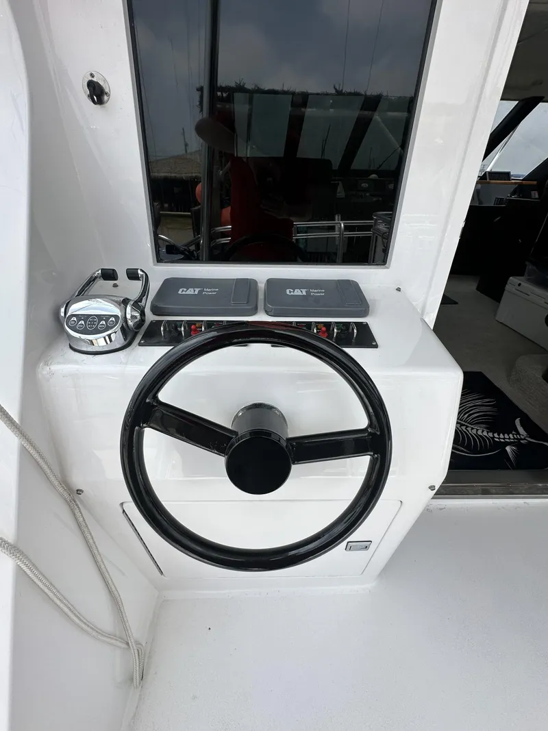 Slide: The Image of 1996 Donzi Custom Enclosed Flybridge helm with steering wheel and controls. - 31