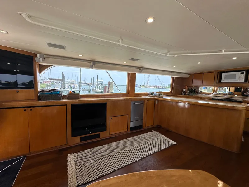 Slide: The Image of Interior of 1996 Donzi Custom Enclosed Flybridge yacht with wooden cabinetry and large windows. - 35